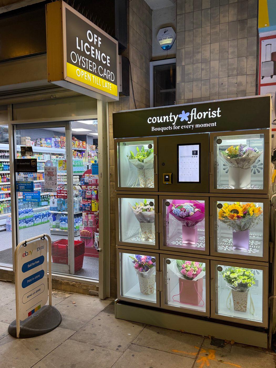 County Florist flower vending machine on Fairfax Road, South Hampstead, stocked with fresh bouquets and lit up at night
